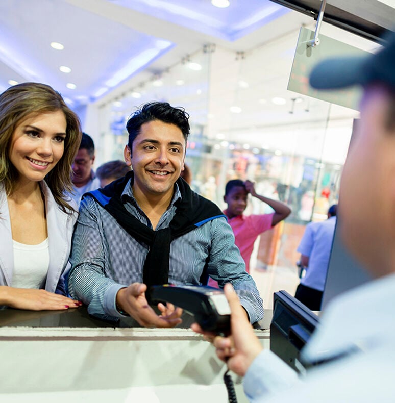 Couple purchasing tickets at a box office